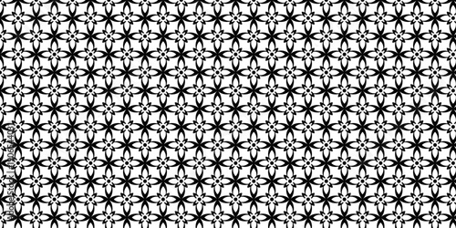 Intricate pattern of black star shapes on a seamless repeating background viewed from directly above