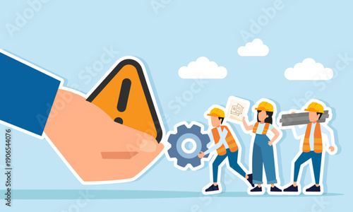 Engineers standing in front of a hand holding a warning sign illustration of caution and awareness in working on a new building project