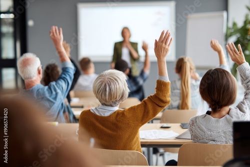 Diverse elderly students raising their hands to ask questions during a university lecture representing lifelong learning active retirement and inclusive adult education in a classroom setting