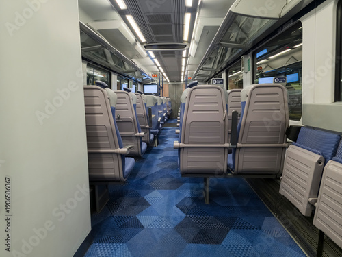 Wallpaper Mural View of interior in a deserted empty commuter train railway carriage with rows of seats and tables Torontodigital.ca