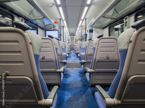 Wallpaper Mural View of interior in a deserted empty commuter train railway carriage with rows of seats and tables Torontodigital.ca