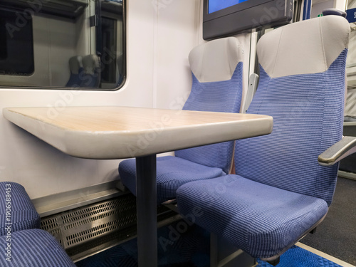 Wallpaper Mural View of interior in a deserted empty commuter train railway carriage with rows of seats and tables Torontodigital.ca