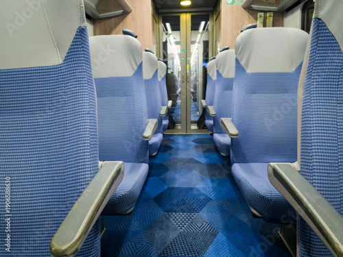 Wallpaper Mural View of interior in a deserted empty commuter train railway carriage with rows of seats and tables Torontodigital.ca