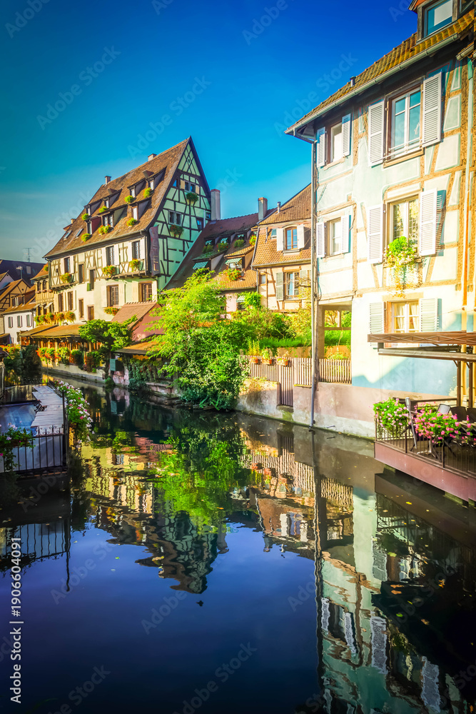 Obraz premium half timbered crooked houses of Colmar with reflections in water, Alsace, France
