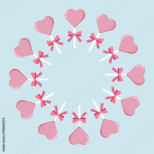 Circular wreath of pink heart-shaped lollipops with bows, evenly spaced on pastel blue background