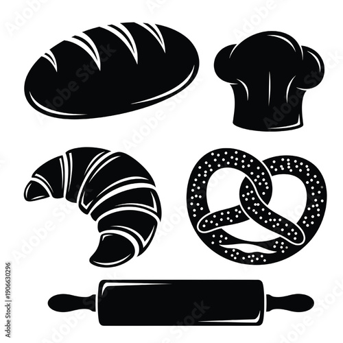 Assorted baked goods including croissant, pretzel, and bread loaf with rolling pin and chef hat