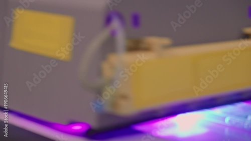 4K footage of a UV printer applying an image to multiple silicone mobile phone cases at once. High-precision digital printing process in modern production or customization setup.