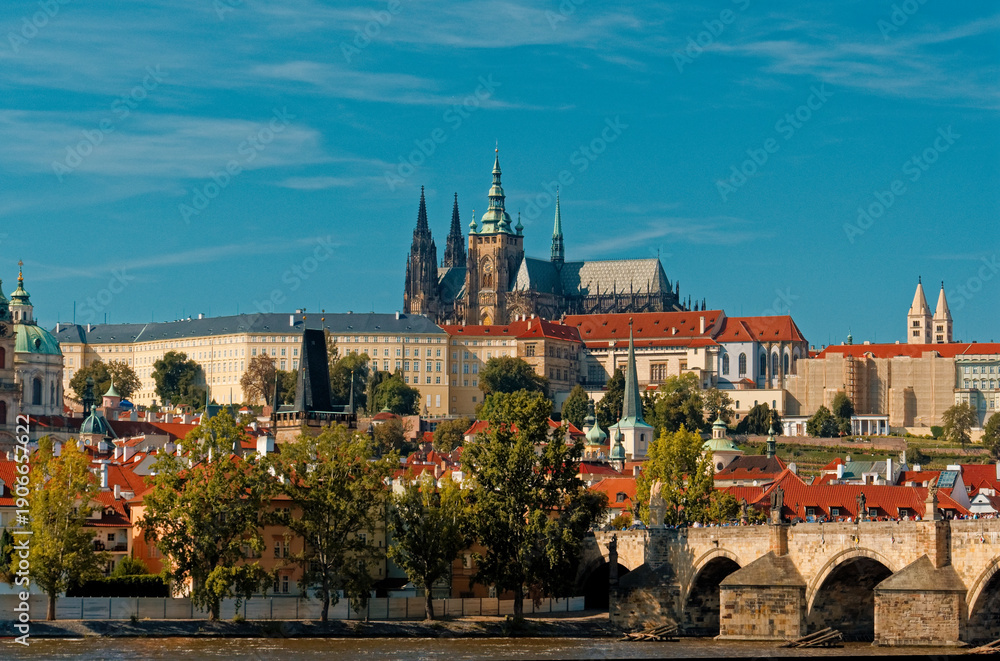 Obraz premium Sunlit Charles Bridge In Prague Showcases Centuries Of Cultural And Architectural Splendor