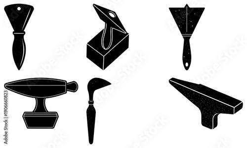 Blacksmithing tools arranged neatly on a white background, viewed from directly above, showcasing various instruments for shaping and crafting metal