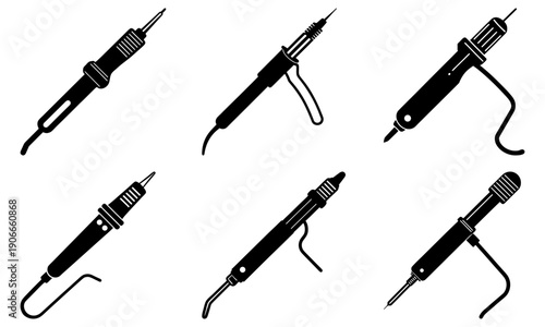 Collection of various electric soldering irons arranged in a grid pattern on a white surface viewed from directly above