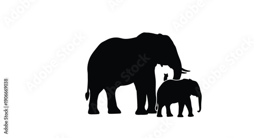An adult elephant and calf stand together in a black silhouette