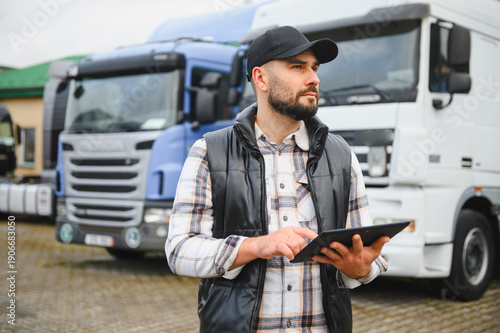 Tableau sur toile Truck driver using digital tablet managing fleet logistics