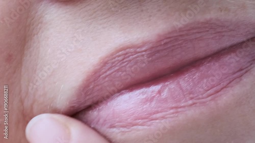 woman's finger checking dry lips, skin around female mouth, nasolabial folds, Women's Health and Self-Esteem concept, Aesthetics of Mature Age, Anti-aging Procedures