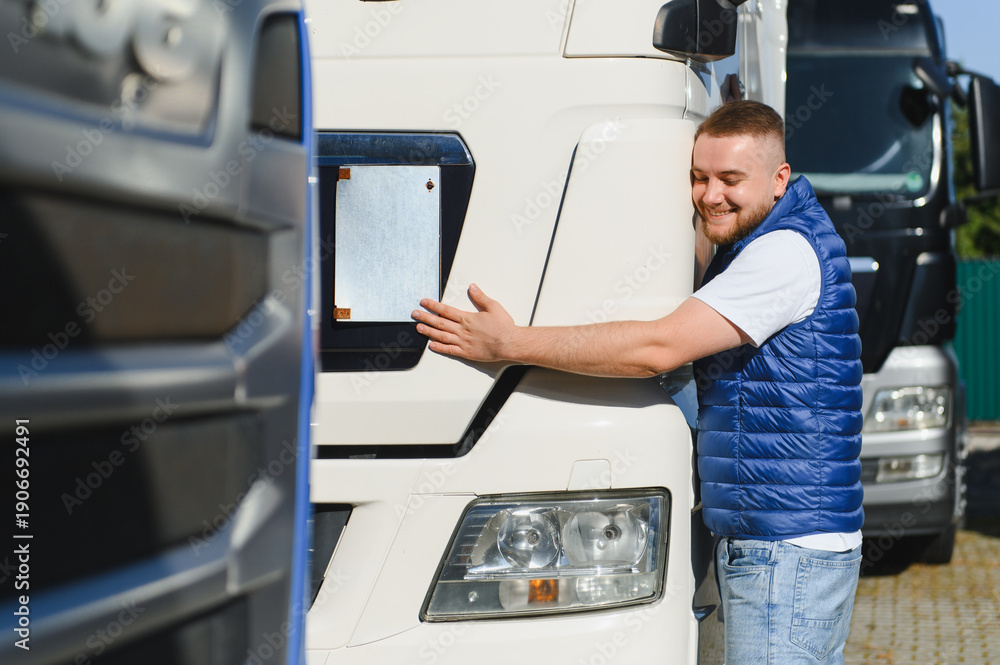 © Serhii - Happy truck driver hugging logistic vehicle © Serhii - Happy truck driver hugging logistic vehicle