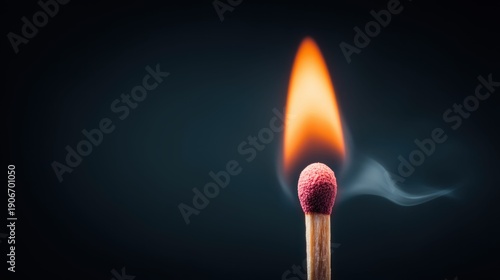Burning matchstick with flame and smoke against a dark background