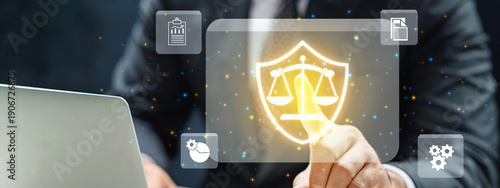 Businessman or lawyer touching a glowing digital shield with scales of justice icon, representing legal technology, corporate compliance, and digital justice protection