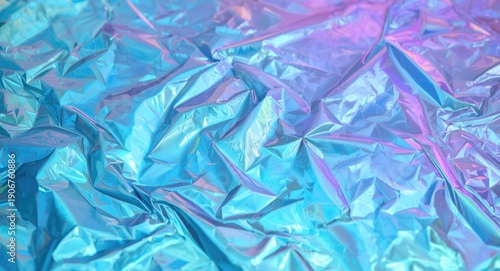 Iridescent holographic flat lay featuring wrinkled surface and abstract colorful background