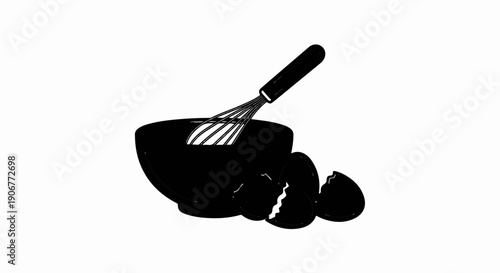 A whisk in a bowl with broken eggshells nearby