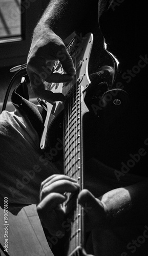 Electric Guitar Player Hands Close-Up in Dramatic Black and White