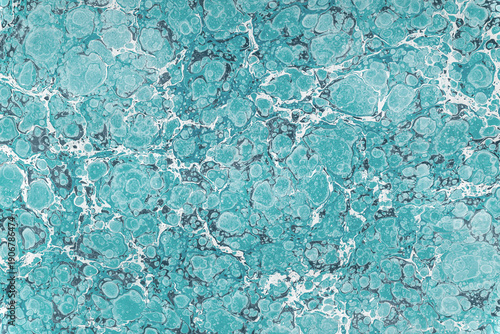 Light blue marble paper creating abstract fluid texture background