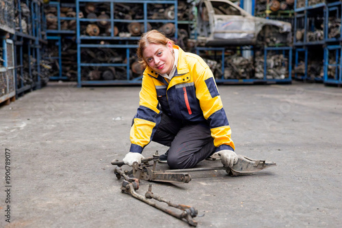 Mechanic checking auto parts in a salvage yard