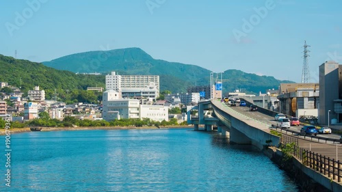 Nagasaki, Japan. A timelapse during the sunny day in Nagasaki, Japan, with a view over the entire center, including the hills.