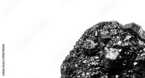 Close shot of magnetite mineral featuring metallic luster and crystal details on white plain background