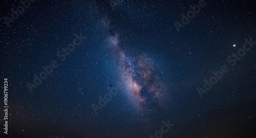 A cosmic nightscape with the Milky Way galaxy and a bright full moon present
