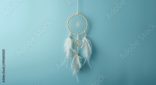 Aerial view of a dream catcher showcasing Asian themed details on a smooth blue background with copy space