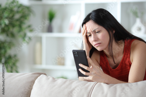 Konstfotografi Worried asian woman checking online content on phone