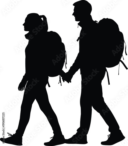 Silhouette of a man and woman hiking together hand in hand with backpacks