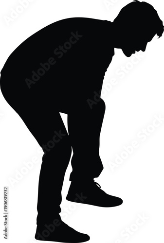 Man bending down in contemplation or sorrow captured in a silhouette artwork from a side profile view