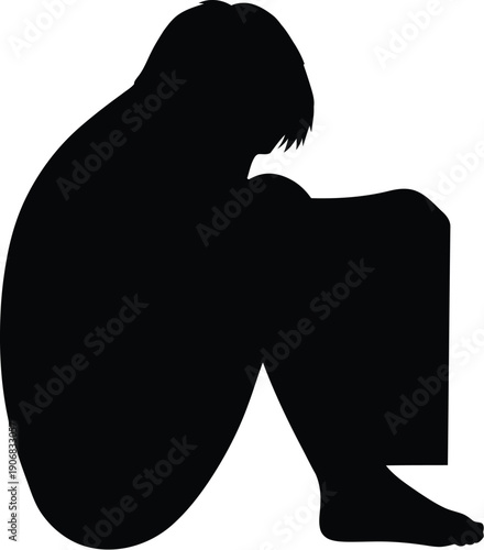 A person sitting alone with head in hands in contemplation outdoors from a side view