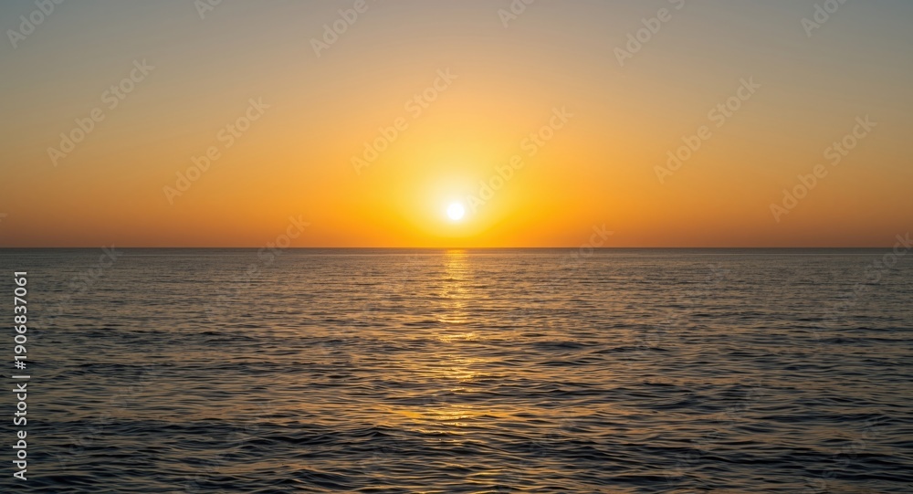 Obraz premium calm ocean waters under glowing sun at horizon
