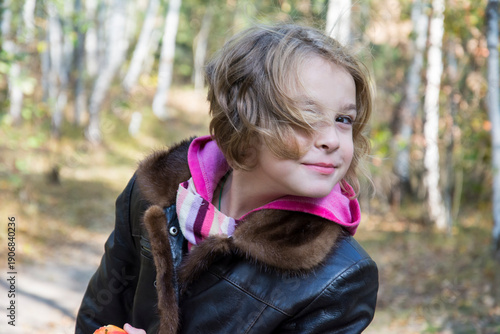 Portrait of laughing young girl in a park