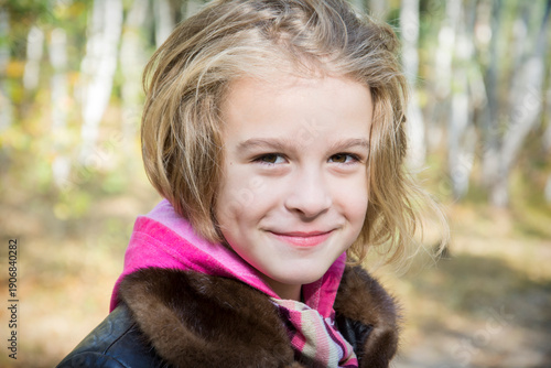 Portrait of laughing young girl in a park