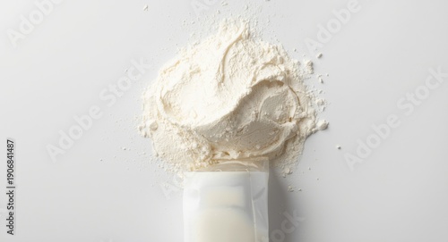 Health food advertisement ready image of colostrum based skim milk powder with spilled texture on white background