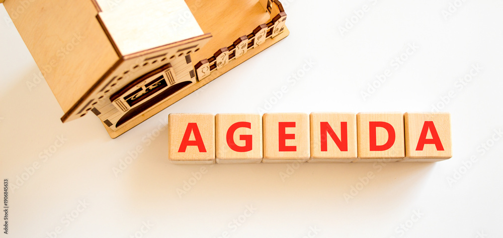 Fototapeta premium Agenda symbol. Concept word Agenda on beautiful wooden blocks. Beautiful white background. Beautiful wooden model of house. Business agenda concept. Copy space.