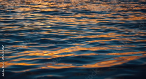 Calm sea reflecting rich su...
