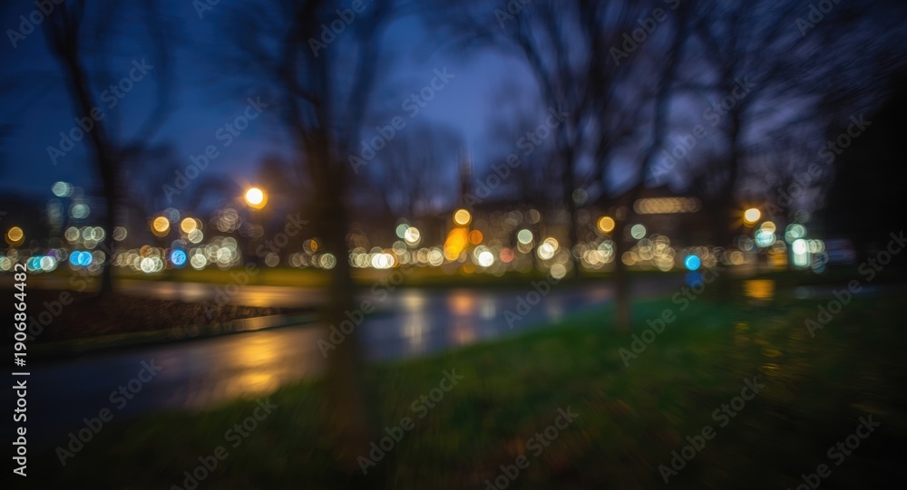 Fototapeta premium Impressionistic view of blurred people in a city park at night with bright bokeh