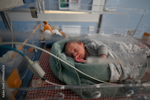 premature baby under observation in a hospital room