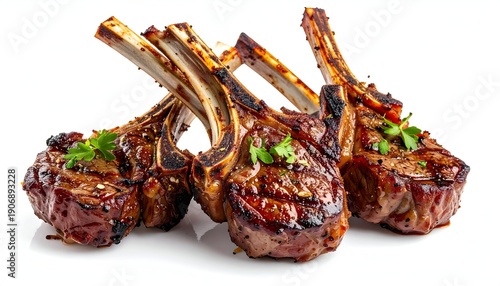 Three grilled lamb chops, parsley garnish, isolated on white background