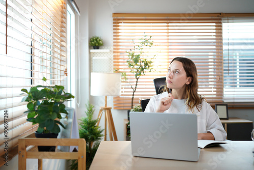 Photos caucasian woman in home office, using laptop for research in remote work, ideas and thinking