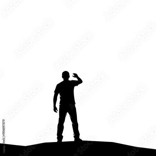 Silhouette of man looking through binoculars on hilltop at sunrise