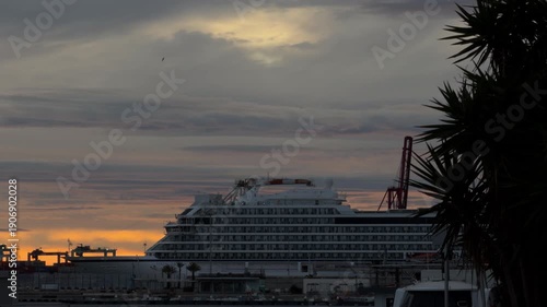 Large cruise ship docked at tropical harbor sunset