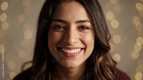 Beautiful smiling woman with long brown hair and a warm expression.