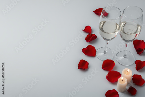 Romantic valentine background wine glass rose petal candle love celebration couple date holiday romance arrangement on white table with copy space for greeting card design