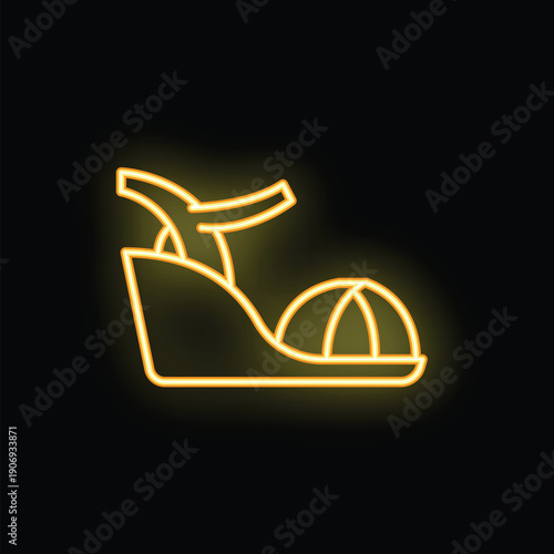 Yellow neon sign of a high heel platform sandal shoe glowing on a black background