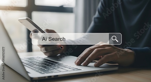 Person searching on laptop with ai search bar and smartphone nearby