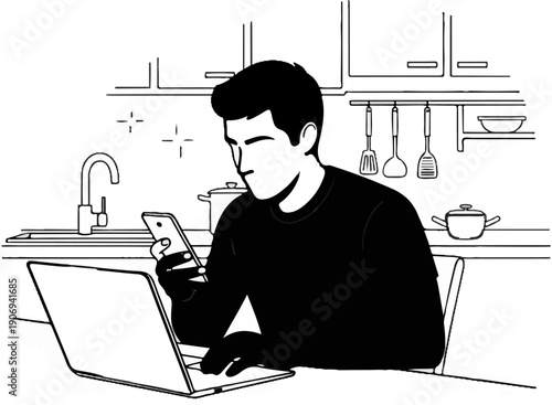 Man in kitchen using phone and laptop